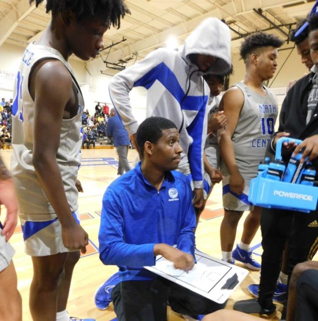 North Central boys' basketball coach Basil Brown instructs his team during a timeout in the St. Landry Parish Basketball tournament.